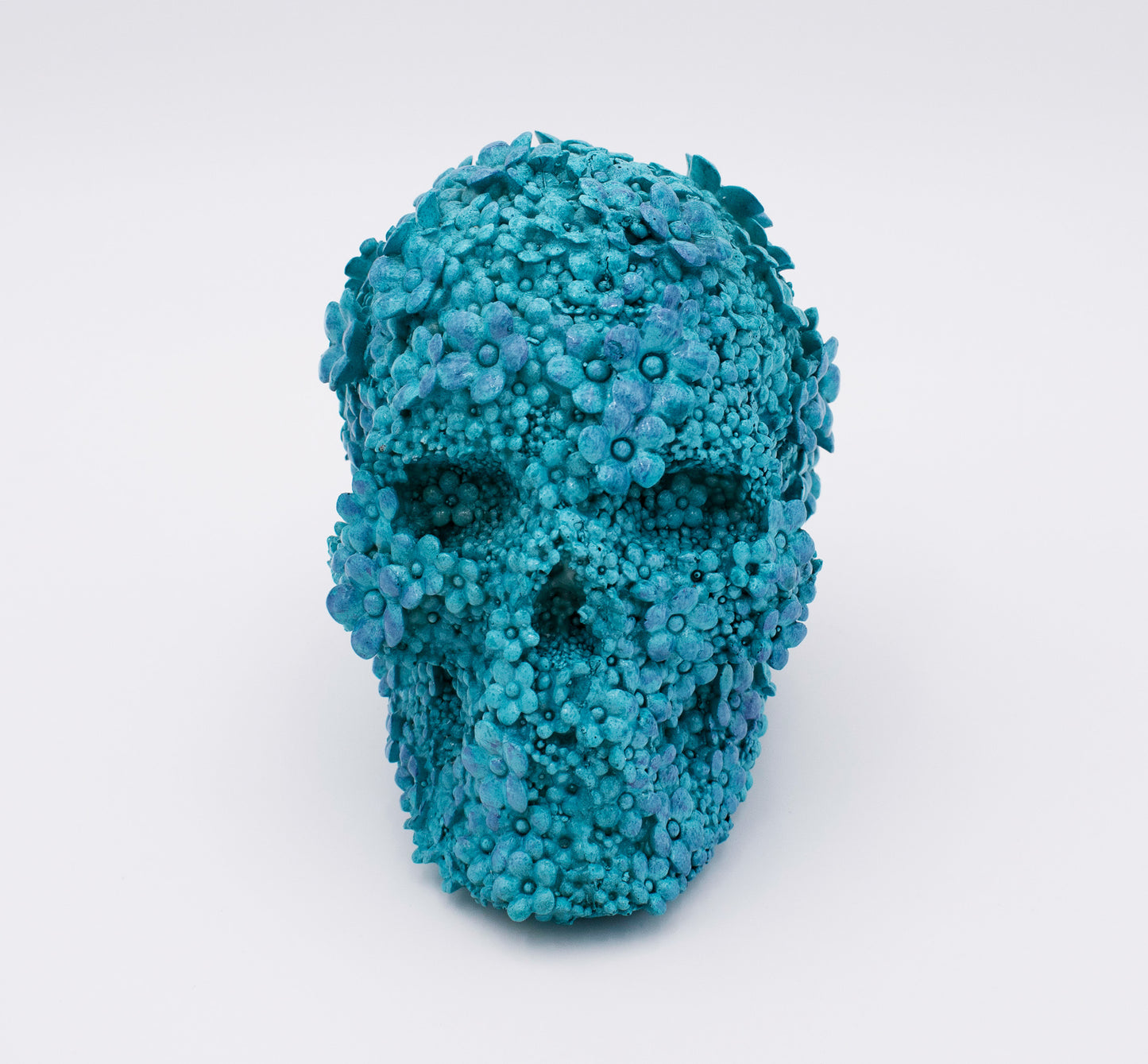 Blue floral skull sculpture on a white background