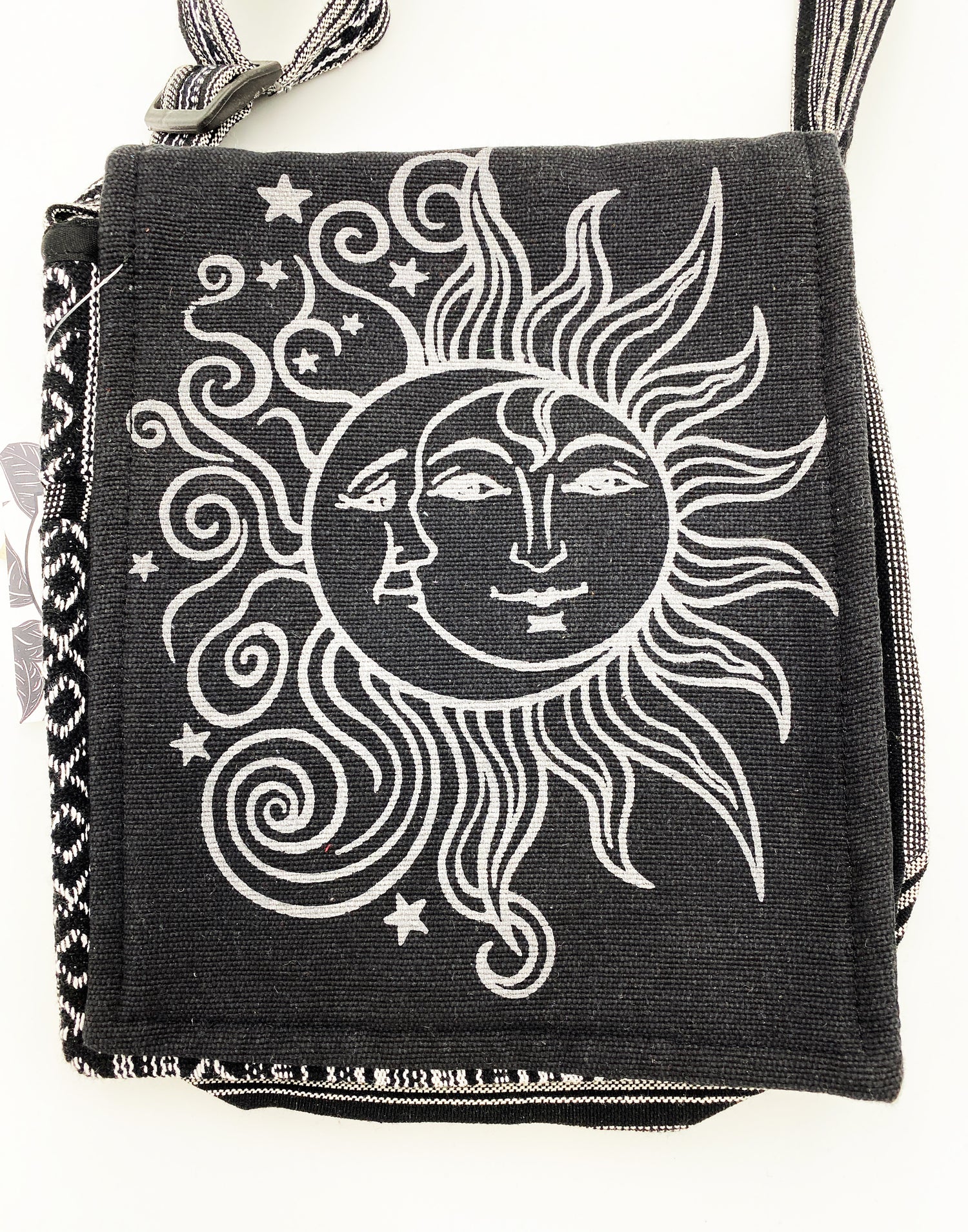 Black bag with white sun and moon design on a white background