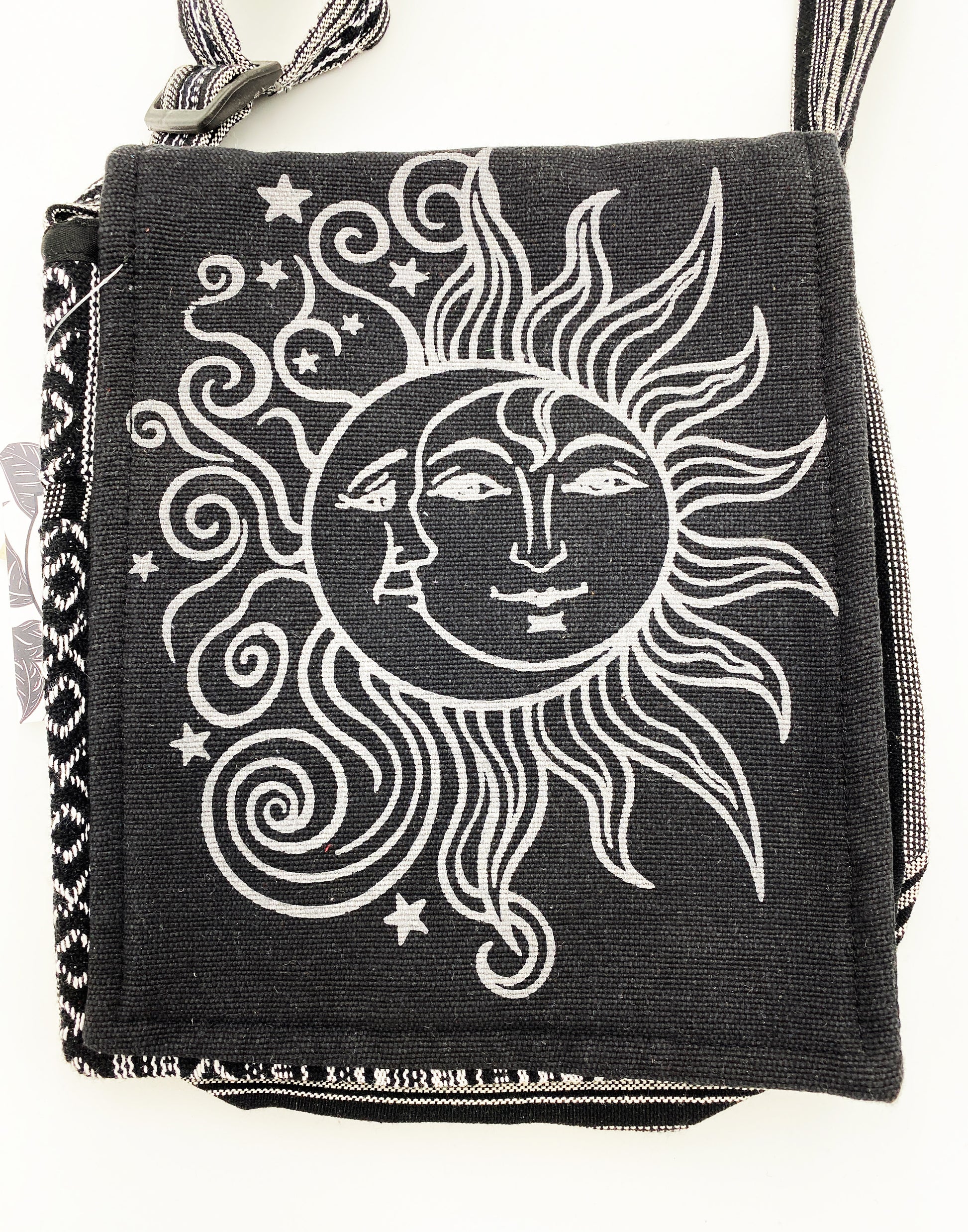Black bag with white sun and moon design on a white background