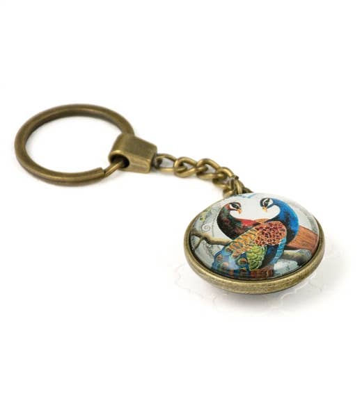 Keychain with a colorful peacock bird design on a white background- Shadowplay Collection Gift Shop