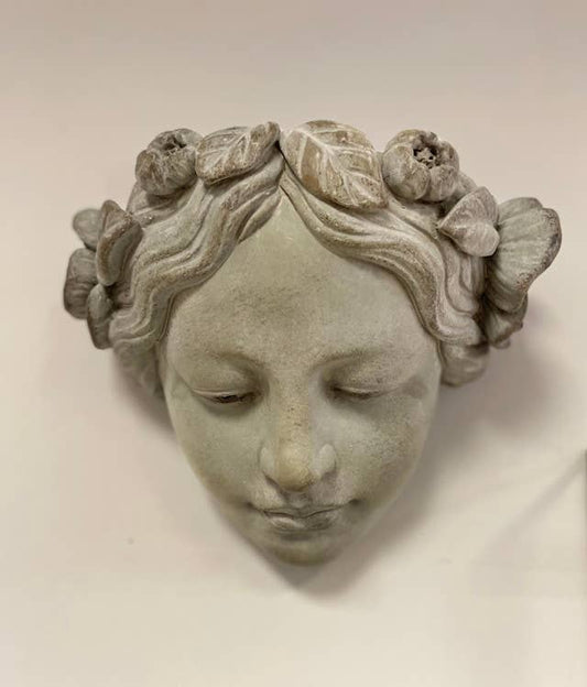 Decorative wall piece of a face with floral crown on a plain background- Shadowplay Collection Gift Shop