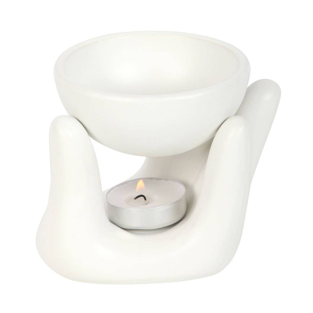 Side View of White ceramic oil warmer with a lit tealight candle on a white background- Shadowplay Collection Gift Shop