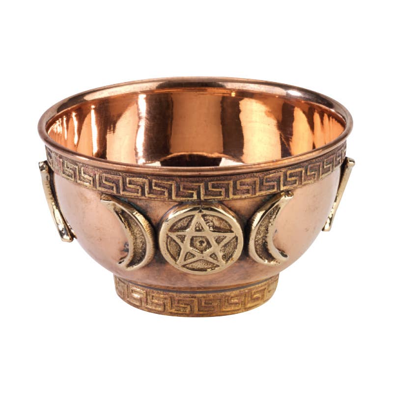 Copper bowl with star and moon designs on a white background