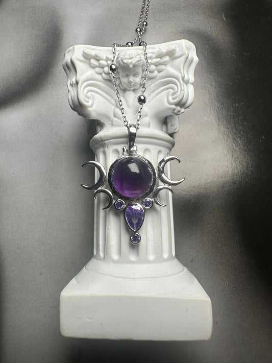 Amethyst pendant necklace on a decorative white column against a gray background- Shadowplay Collection Gift Shop
