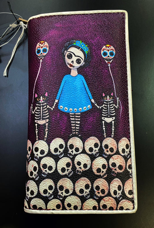 Faux Leather wallet with artistic design of Frida Kahlo inspired figure with skeletons and skulls on a purple  background