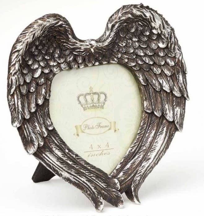 Heart-shaped photo frame with angel wings on a white background