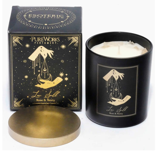Black candle with gold label and packaging in the background- Shadowplay Collection Gift Shop