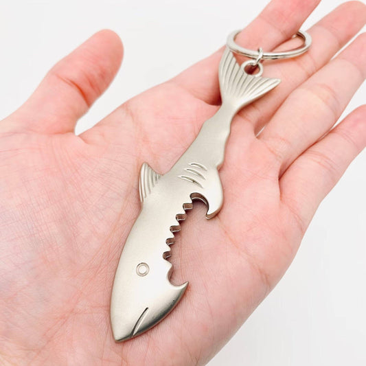 Shark-shaped bottle opener held in a hand against a white background- Shadowplay Collection Gift Shop San Antonio, TX