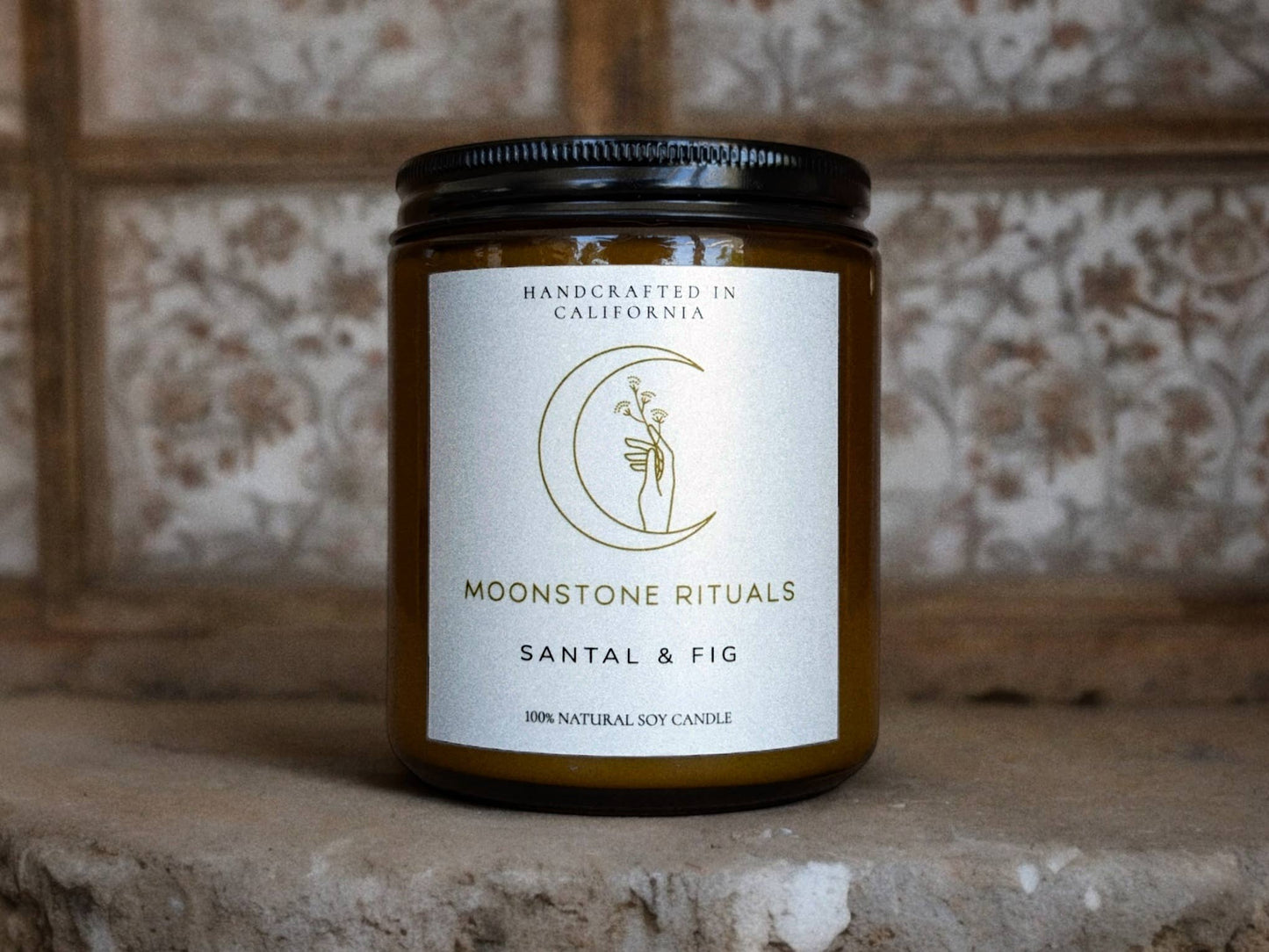 Moonstone Rituals candle with label on a textured surface