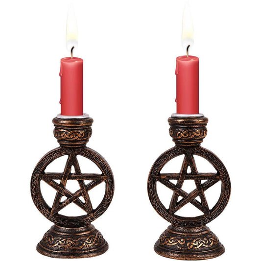 Two candle holders with pentagram design on a white background