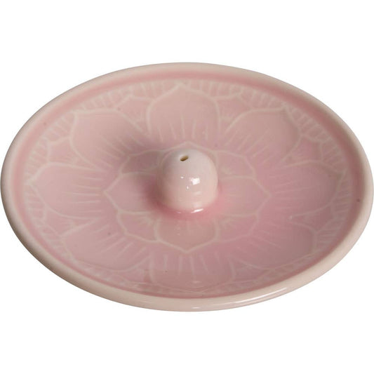 Pink ceramic incense burner with a central hole on a white background
