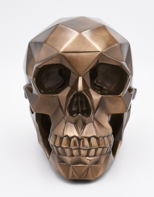 Bronze geometric skull sculpture on a white background