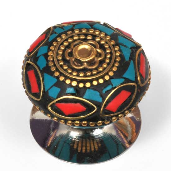 Decorative knob with intricate design on a white background