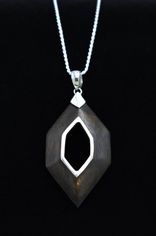 Silver and Sono Wood pendant necklace on a black background