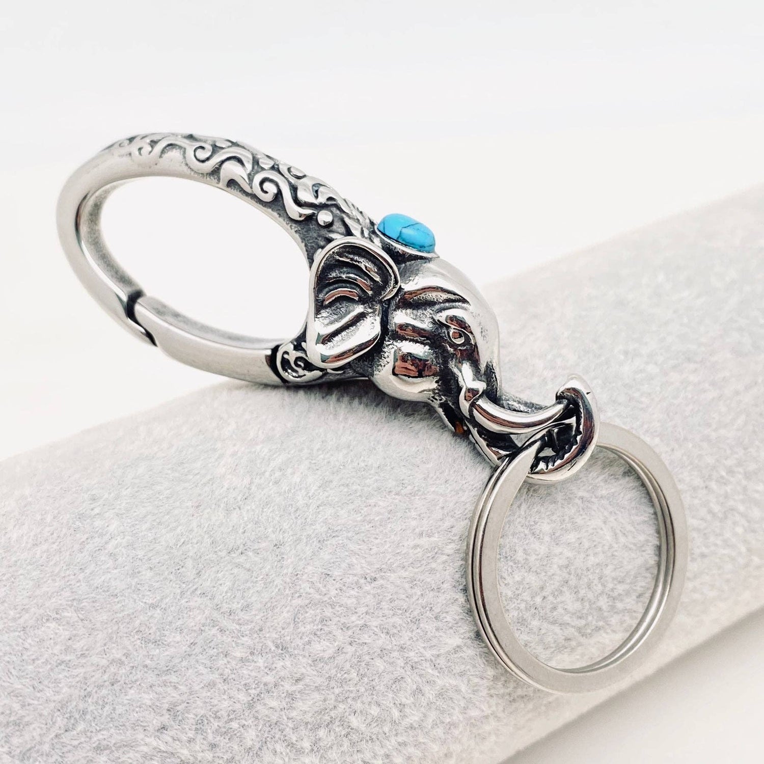 Silver elephant keychain with faux turquoise stone on a white background- Shadowplay Collection Gift Shop