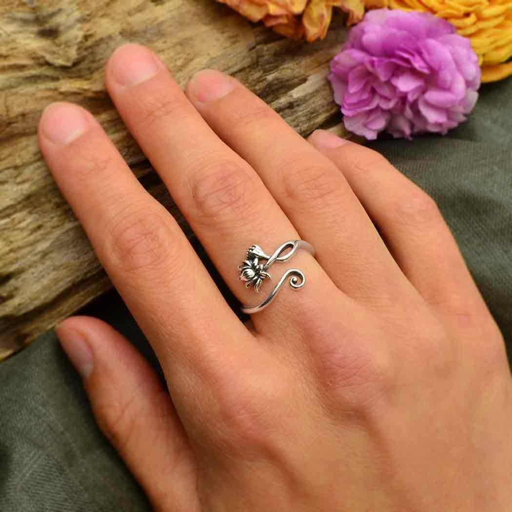 Sterling Silver Adjustable Lotus Ring on a hand with a flower - Shadowplay Collection Gift Shop