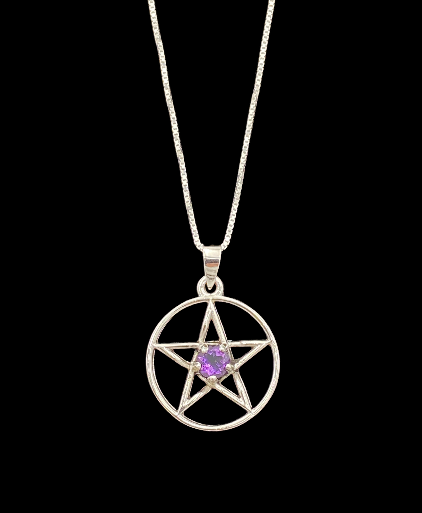 Silver pentacle pendant with a purple gemstone on a black background