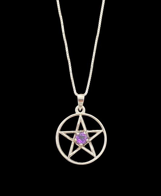 Silver pentacle pendant with a purple gemstone on a black background