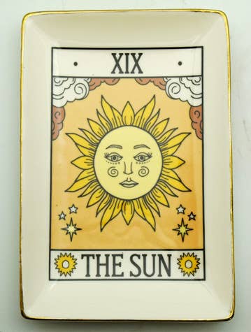 Decorative plate with 'The Sun' tarot card design on a beige background