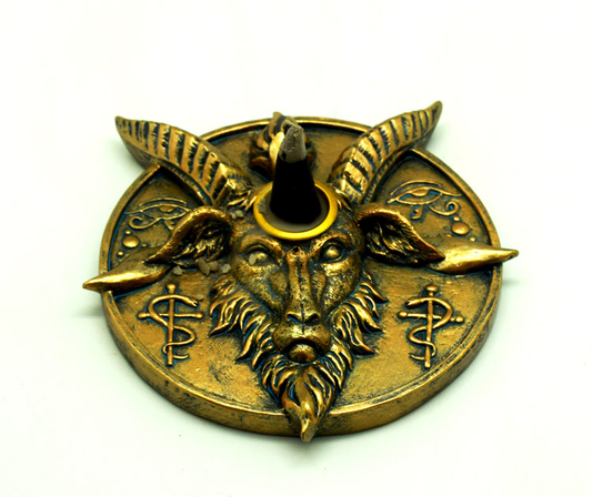 Gold goat head with horns incense holder on a white background