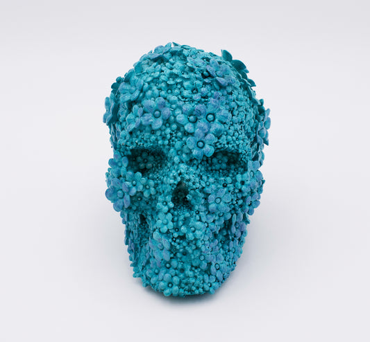 Blue floral skull sculpture on a white background